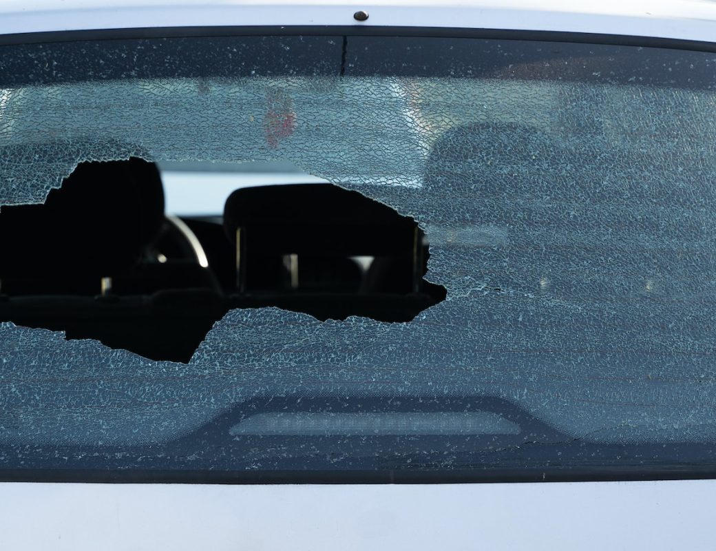closeup of broken rear windshield glass on the back of a car